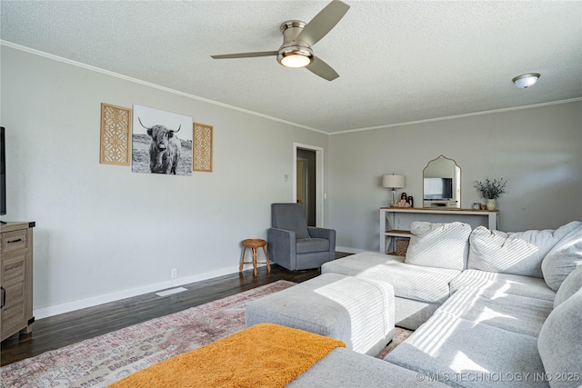 living room featuring ceiling fan, crown molding, dark hardwood / wood-style floors, and a textured ceiling