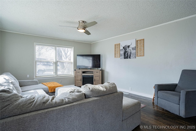 living room with crown molding, dark wood-type flooring, a textured ceiling, and ceiling fan