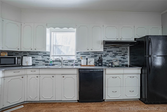 kitchen featuring sink, decorative backsplash, black appliances, and white cabinets