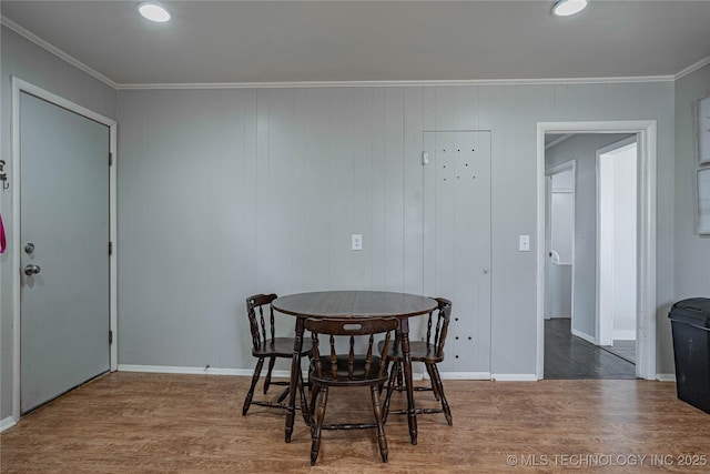 dining room featuring hardwood / wood-style flooring and ornamental molding