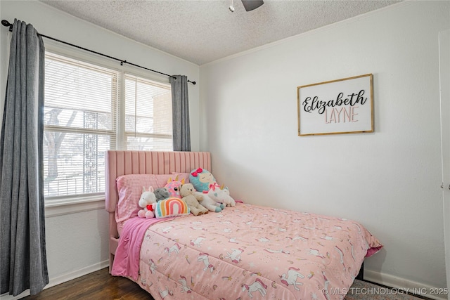 bedroom with ceiling fan, dark hardwood / wood-style floors, and a textured ceiling