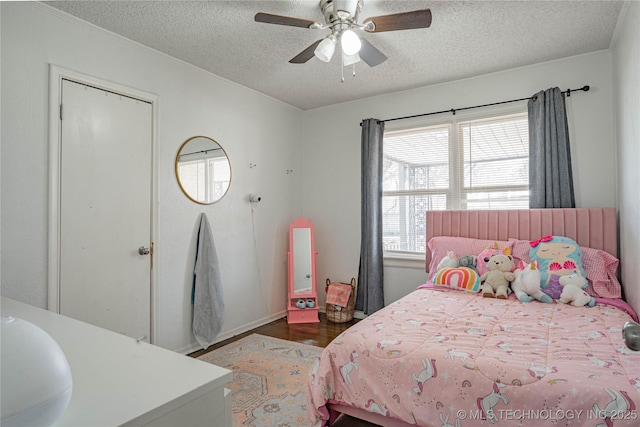 bedroom featuring dark wood-type flooring, ceiling fan, sink, and a textured ceiling