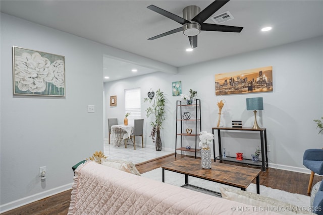 living room with dark hardwood / wood-style floors and ceiling fan
