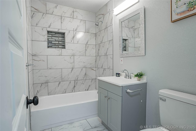 full bathroom with vanity, toilet, and tiled shower / bath