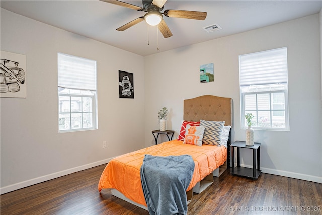 bedroom with dark wood-type flooring and ceiling fan