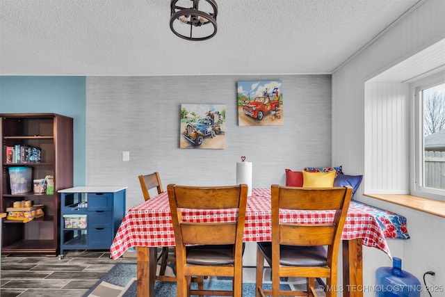 dining space with a textured ceiling