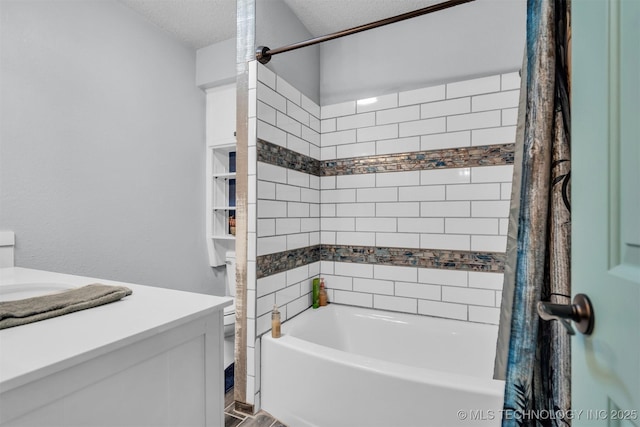 full bathroom with shower / bath combination with curtain, vanity, toilet, and a textured ceiling