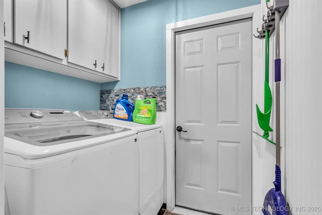 laundry area featuring cabinets and washer and clothes dryer