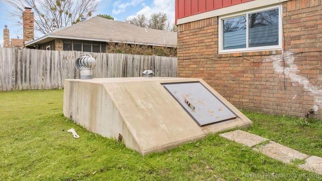 view of storm shelter with a yard