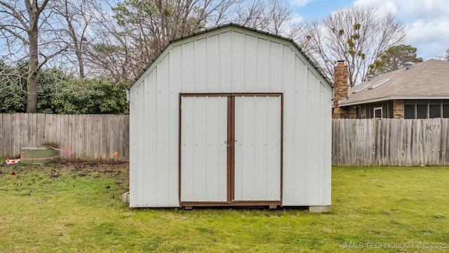 view of outdoor structure featuring a lawn