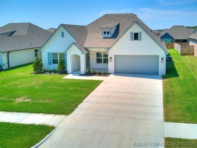 view of front of property featuring a garage and a front yard