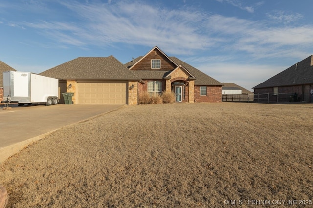 view of front of house featuring a garage and a front lawn