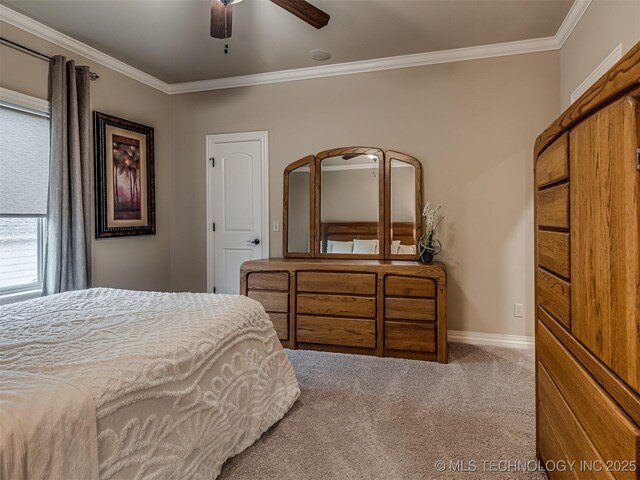 carpeted bedroom featuring ceiling fan and ornamental molding