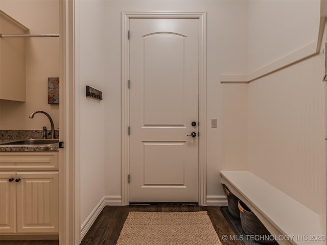 doorway to outside featuring sink and dark hardwood / wood-style floors