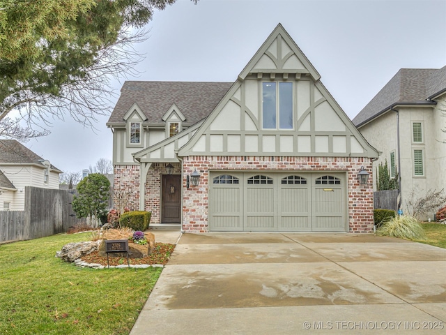 english style home featuring a front lawn and a garage