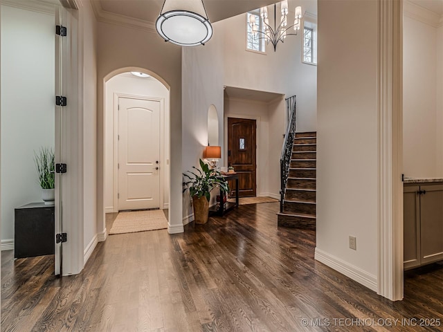 entryway featuring ornamental molding and dark hardwood / wood-style floors