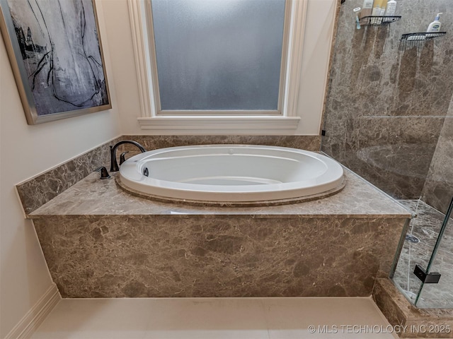 bathroom featuring tiled bath
