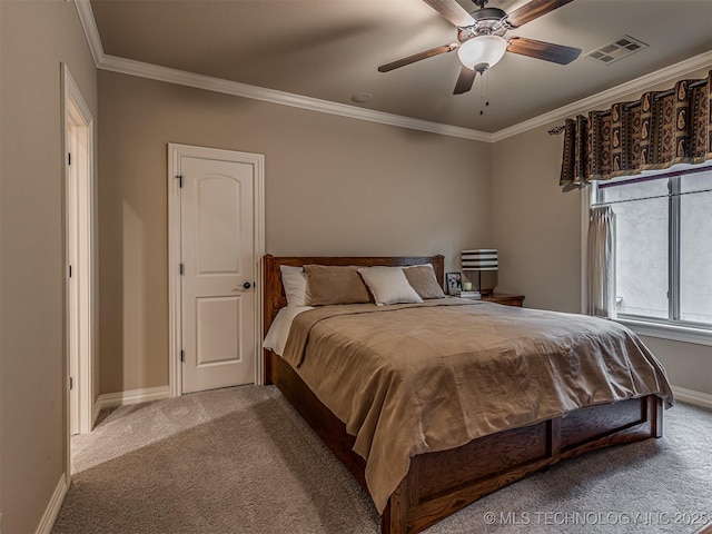 carpeted bedroom featuring ornamental molding and ceiling fan