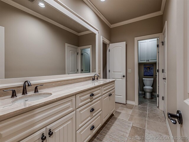 bathroom with toilet, crown molding, and vanity