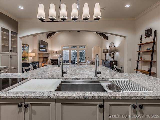 kitchen featuring white cabinets, crown molding, and decorative light fixtures