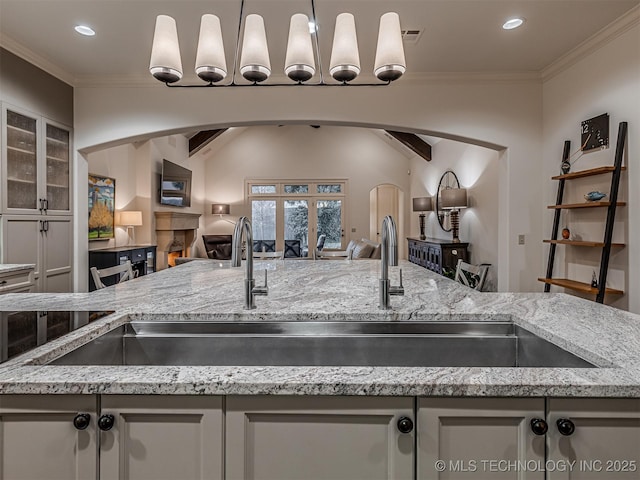 kitchen with sink, crown molding, and white cabinets