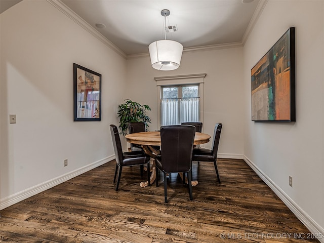 dining space featuring ornamental molding and dark wood-type flooring
