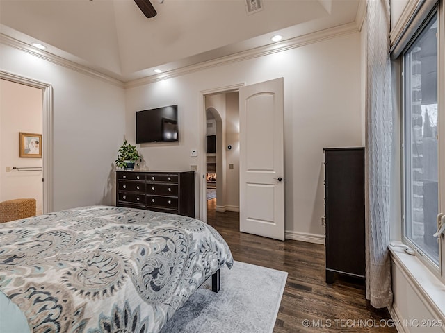 bedroom with ceiling fan, lofted ceiling, dark hardwood / wood-style flooring, and ornamental molding