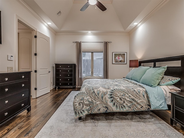 bedroom with ceiling fan, vaulted ceiling, crown molding, and dark hardwood / wood-style flooring