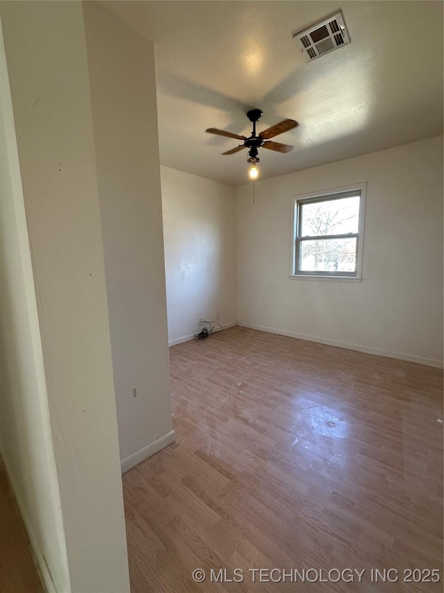 spare room with light hardwood / wood-style floors and ceiling fan