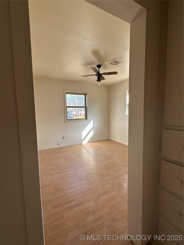 spare room with light hardwood / wood-style floors and ceiling fan