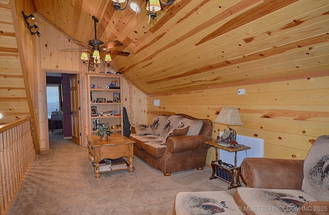 carpeted living room with wooden walls, vaulted ceiling, and wooden ceiling