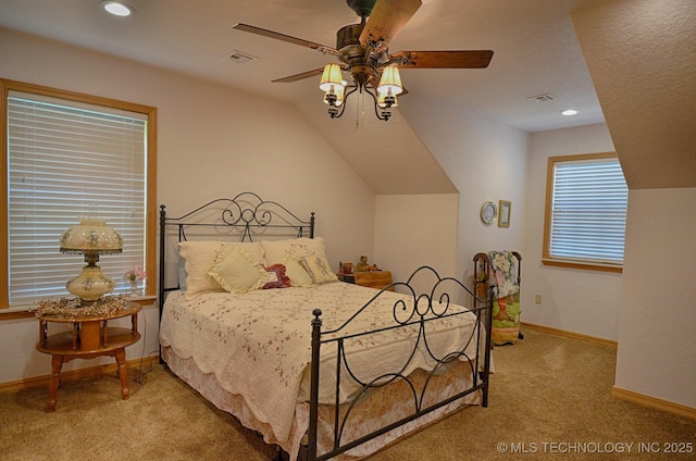 bedroom with ceiling fan, light colored carpet, and vaulted ceiling