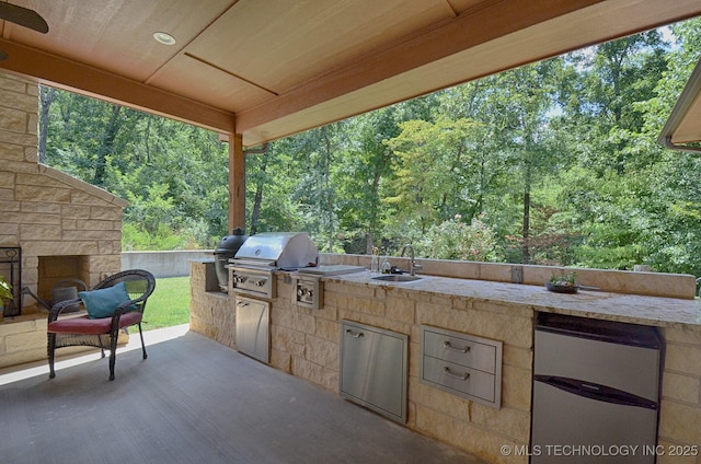 view of patio featuring exterior kitchen, a grill, and sink