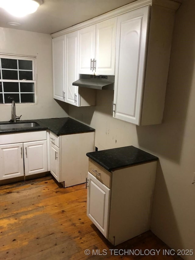 kitchen with sink, dark wood-type flooring, and white cabinets