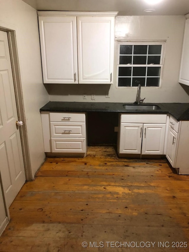 kitchen featuring sink, white cabinets, and dark hardwood / wood-style flooring