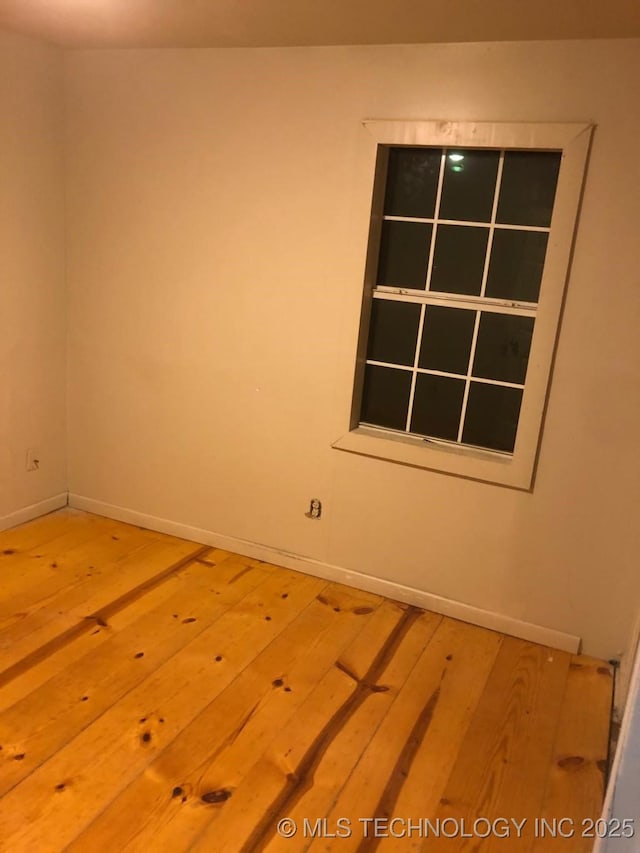 empty room with hardwood / wood-style flooring