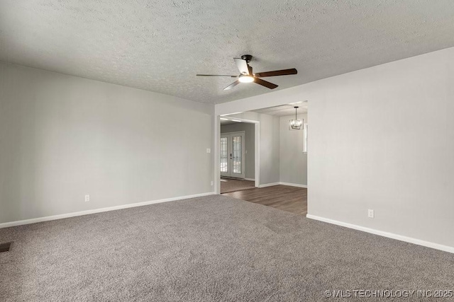 spare room with dark carpet, a textured ceiling, and ceiling fan