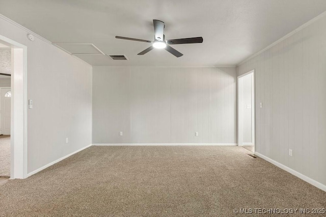 empty room featuring crown molding, ceiling fan, and carpet