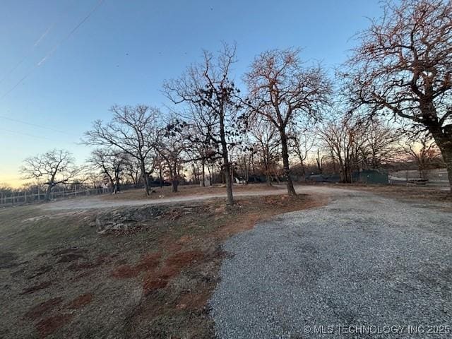 yard at dusk with a rural view