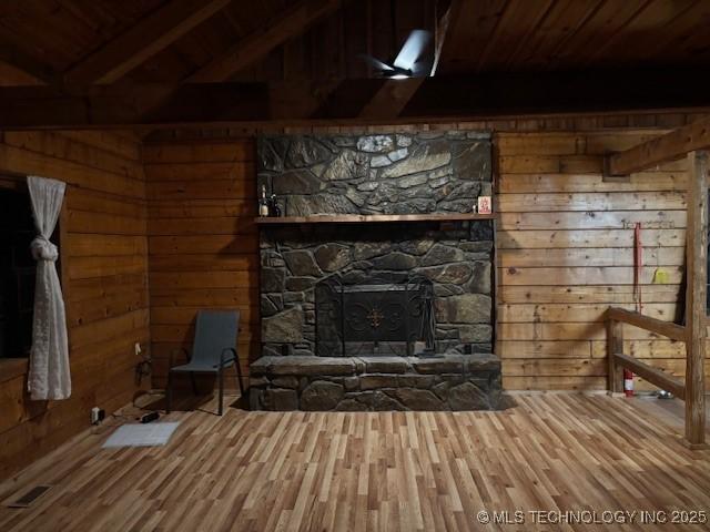 unfurnished living room featuring wood ceiling, wood walls, lofted ceiling with beams, and wood-type flooring