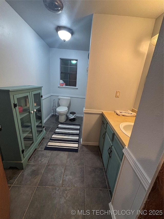bathroom featuring toilet and vanity