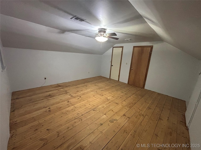 additional living space featuring hardwood / wood-style floors, lofted ceiling, and ceiling fan