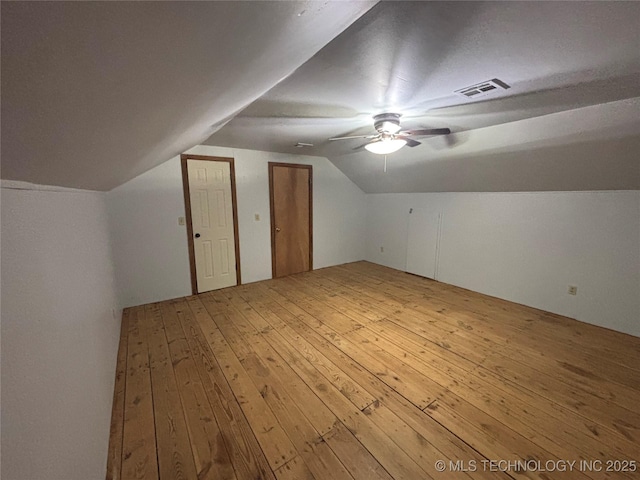 bonus room featuring hardwood / wood-style flooring, vaulted ceiling, and ceiling fan