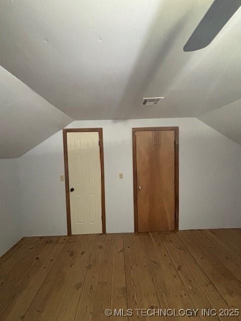 additional living space featuring hardwood / wood-style floors and vaulted ceiling