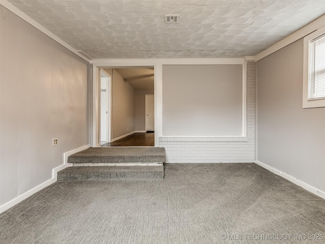 spare room with dark carpet and a textured ceiling