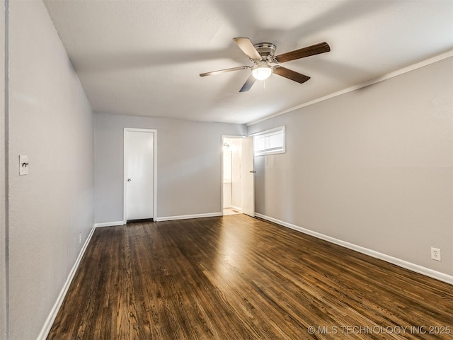 spare room with ceiling fan and dark hardwood / wood-style floors