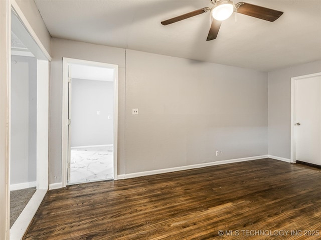 spare room with ceiling fan and dark hardwood / wood-style flooring