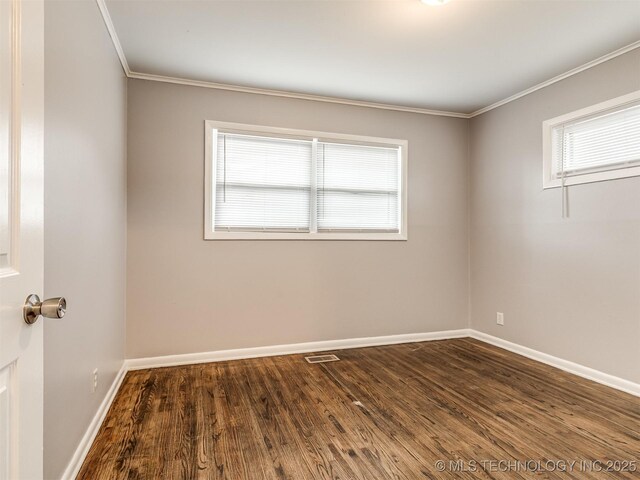 unfurnished room with ornamental molding and dark hardwood / wood-style flooring