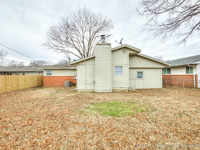 rear view of property featuring central AC