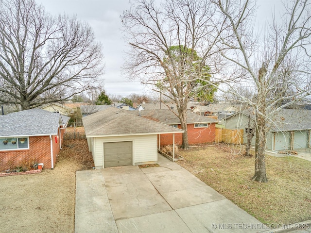 view of side of property featuring a garage and a lawn